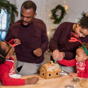 family building gingerbread houses together
