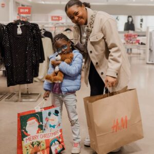 A woman posing with her shopping spree buddy
