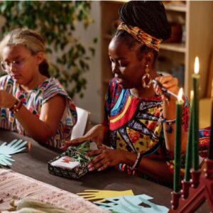 Woman and daughter celebrating Kwanzaa at the table