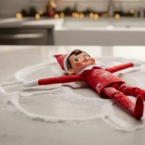 elf on the shelf making a snow angel on the counter