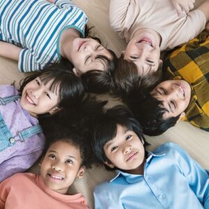 Kids laying in a circle on the floor