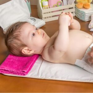 baby laying on a changing table