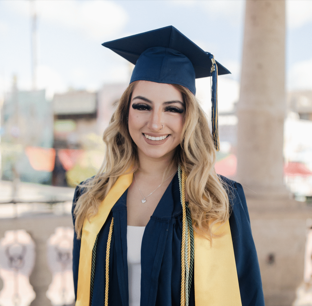 Foster Love Family Fellowship scholar posing in her cap, gown, and sash