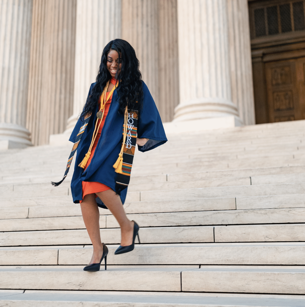 Foster Love Family Fellowship scholar walking down steps in her graduation gown.