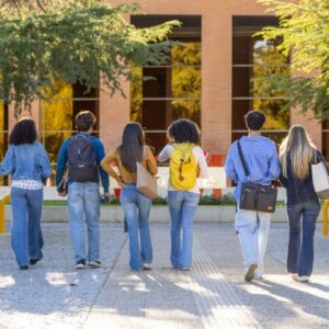 a row of students walking in a college campus