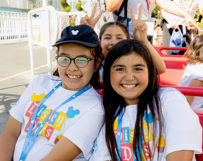Sisters on a ride at Disney Days
