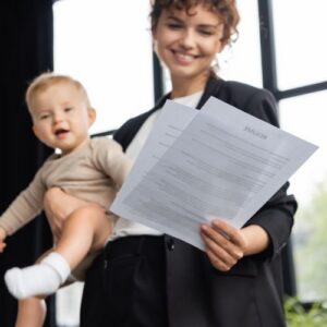 woman holding baby and adoption papers