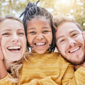 a girl between her mom and dad