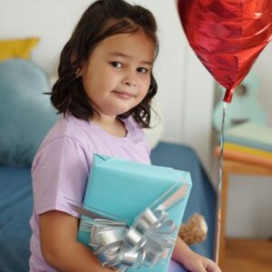 girl with a present and balloon