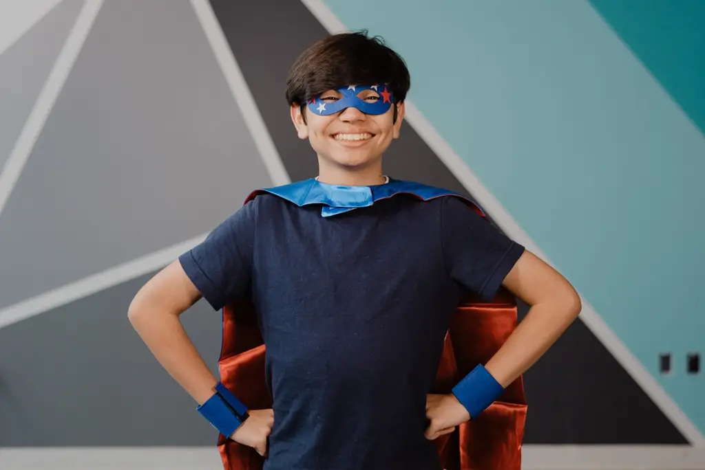 child wearing superhero box items