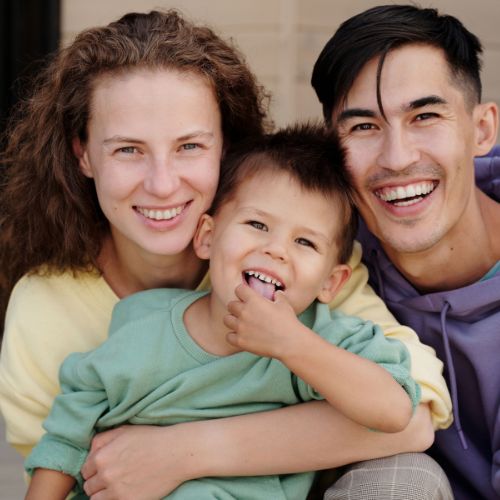 a happy family, mom, dad, and child