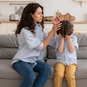woman helping her upset son