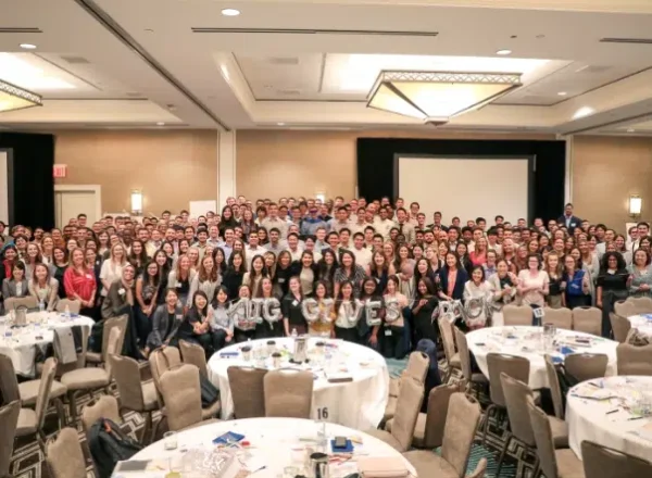 Gallery_6 AIG employees posing for a large group shot, holding AIG Gives balloons in the front