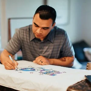 man decorating superhero pillowcase