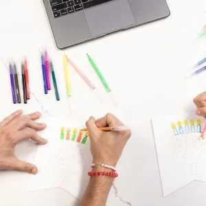 mel-and-mitch-doing-birthday-kit-vsp-2 Two people working on a birthday kit