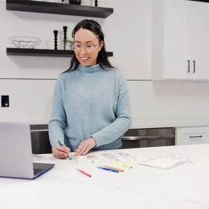 mel-doing-stem-kit-vsp Woman building a virtual STEM kit in front of a laptop