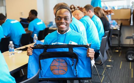 Man holding a Sweet Case with a basketball painted on it.