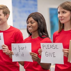 young-volunteers-holding-up-signs.original young-volunteers-holding-up-signs.original